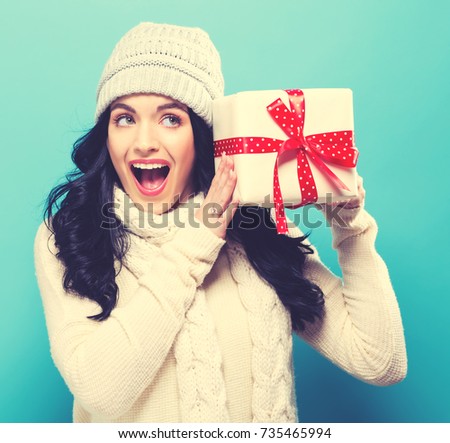 Young woman holding a Christmas gift box