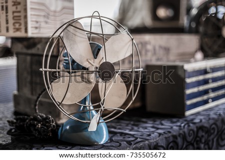 Vintage fan sitting on table with cloth