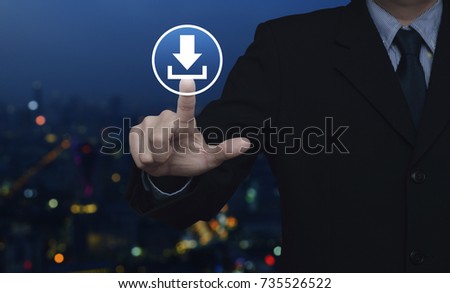 Businessman pressing download icon over blur colorful night light city tower, Business internet concept
