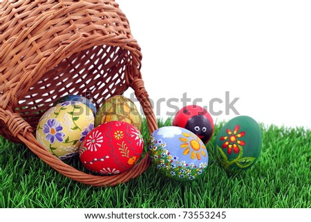 Hand painted beautiful  colorful  easter eggs in wicker basket on fresh green grass