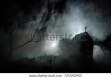 Scary view of zombies at cemetery dead tree, moon, church and spooky cloudy sky with fog, Horror Halloween concept. Toned
