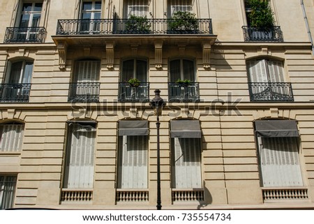 Paris residential buildings. Old Paris architecture, beautiful facades, typical french houses. Famous travel destinations in Europe. Background. City life, lifestyle and expensive real estate concept.
