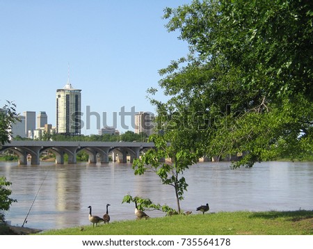 Tulsa Oklahoma from the west bank of the Arkansas River with baby geese and a fishing pole