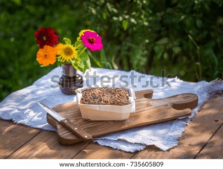 Still life with organic bread. Tasty fresh baked bread photographed on table in garden