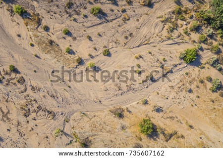 Lines left in a sandy creek bottom mark the passage of water through a desert wash.