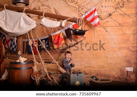 Little boy child dressed as pirate for Halloween. Kid in carnival costumes for Christmas or New Year. Pirates studio background. Foto without computer edition.