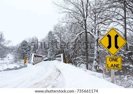 Narrow Bridge Over Country Road in Winter