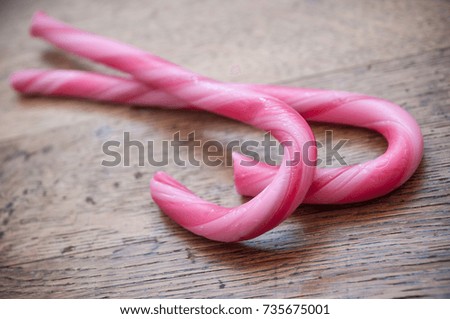 closeup of candy canes on wooden background