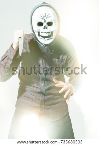 halloween horror picture of man with creepy mask and knife