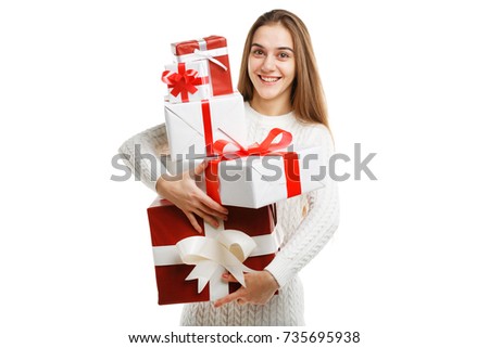 Cute smiling little girl holding christmas gift isolated on white background. Holiday concept.