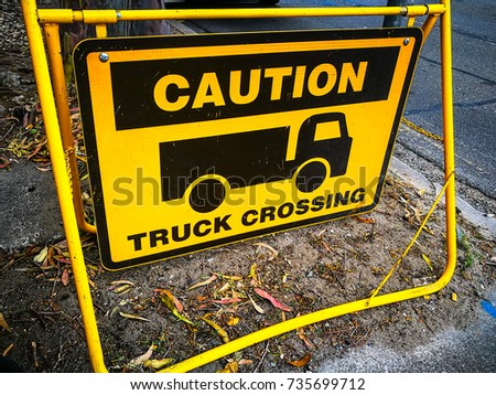 Yellow square Caution sign for truck crossing, shared use of the roadway by trucks might occur.