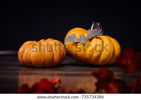 for decorating a house for Halloween, lie 2 pumpkins and a burning candle