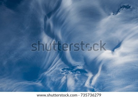 Deep blue winter sky with thin wispy clouds, New Hampshire, USA.

