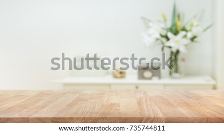 Real wood table top texture on white wall room background.For create product display or design key visual layout