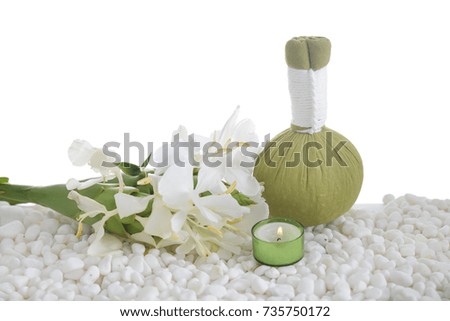 ginger flower with herbal ball , candle on pile of white stones