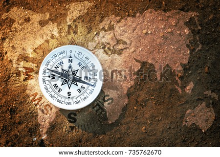 Compass and world map on dry soil, Flat top view, Find the right way for our earth concept