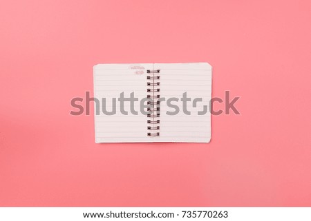 Blank notebook  on top of pink pastel desk. Top view with copy space, flat lay.