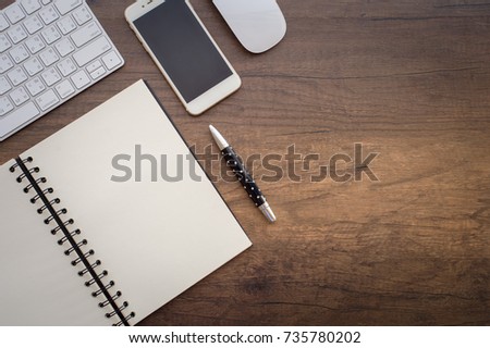 Picture for Business,Business desk Open notebook, Blank notebook Folding on Wooden Background with a keyboard, mouse and pen on wooden table