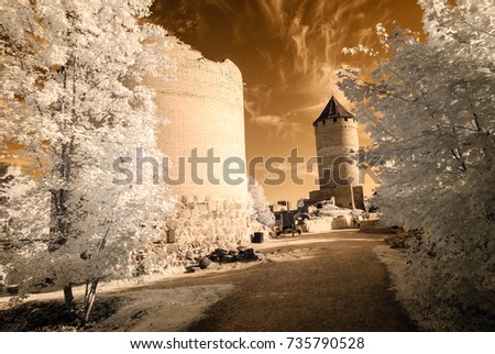 public forest park view in Turaida Sigulda, Latvia with contrasty clouds above and ruins of old castle. infrared image