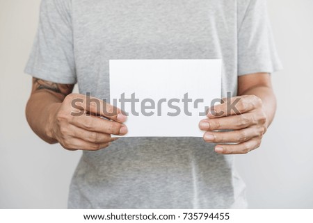 Close-up a man holding blank white paper