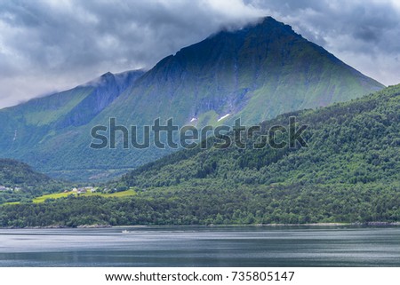 Serene Scandinavian landscape seascape with islands, blue skies and puffy clouds. 
