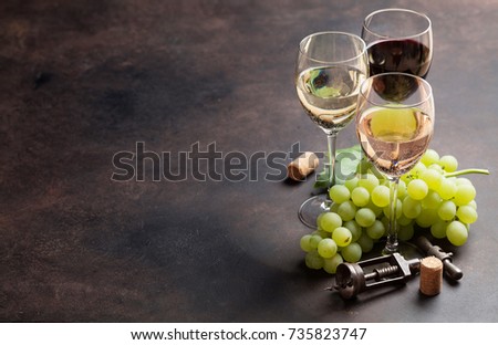 Wine glasses and grapes on stone table. With space for your text