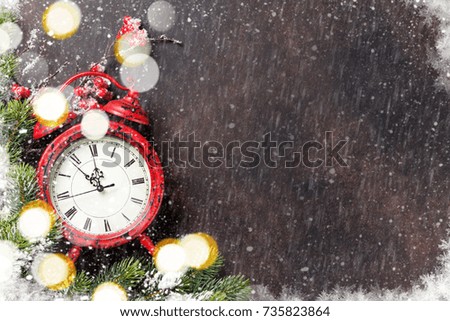 Xmas greeting card. Christmas background with snow fir tree and alarm clock. View from above with space for your greetings
