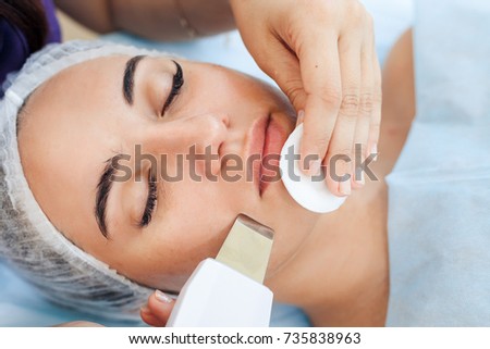 Face skin care. Woman getting facial ultrasound cleaning at beauty salon