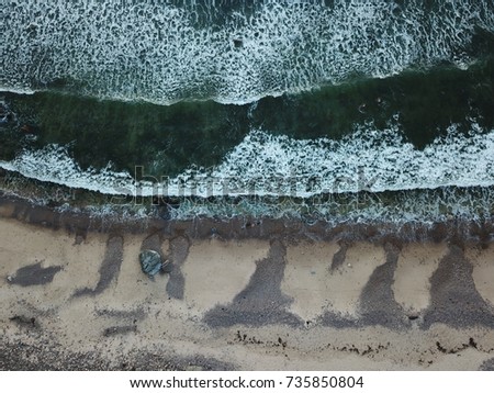 Half dry Half wet, this picture has been taken by a drone, showing the point where ocean waves break at the beach.
