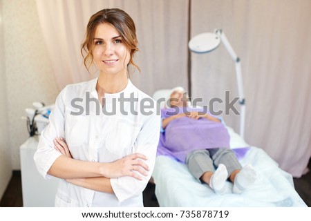 Cosmetologist, portrait of a beautician doctor on the background of the office Royalty-Free Stock Photo #735878719