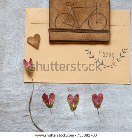 Leaves on the wooden grey background and a leather purse