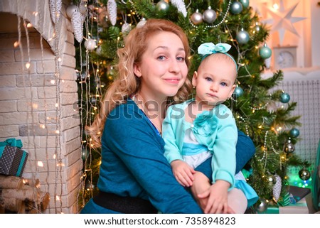 Mom and daughter on a background of beautiful Christmas decorations