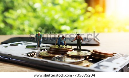 Three miniature mini  figures with keep money in mobile. Cashless Society Concept pay with Application mobile phone