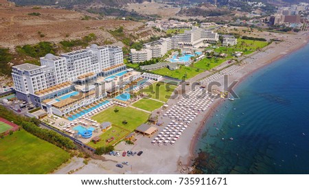 Aerial birds eye view photo taken by drone of crowded beach of Kalithea with popular resorts, Rhodes island, Greece