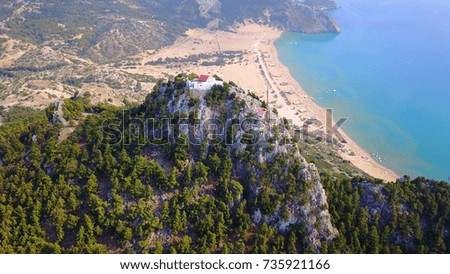 Aerial birds eye view photo taken by drone of famous beach of Tsampika and church uphill overlooking the beach, Rhodes island, Dodecanese, Greece