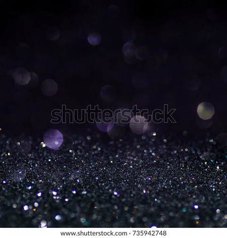 Abstract holiday lights in dark colors. Square image. Glitter background. Selective focus.