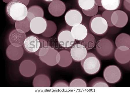 Bokeh of pastel magenta color on dark background