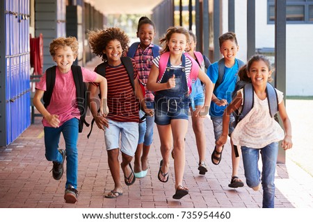 School kids running in elementary school hallway, front view Royalty-Free Stock Photo #735954460