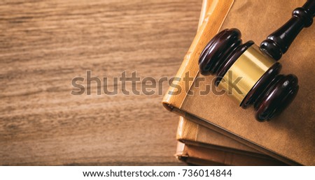 Law theme, lawyer's desk. Judge gavel on legal books, wooden background, copy space, top view
