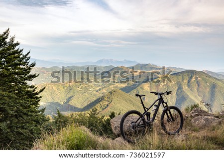 Mountain bike sunset silhouette on forest trail, inspiring landscape. Cycling bike on rural country road. Full suspension bicycle, inspirational sports concept outdoors.