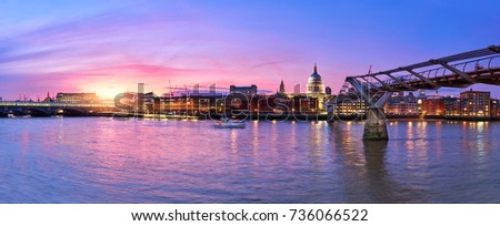 Illuminated London, view over Thames river from South Bank Ennbankment towards Millenium footbridge and St. Paul's cathedral on the sunset.