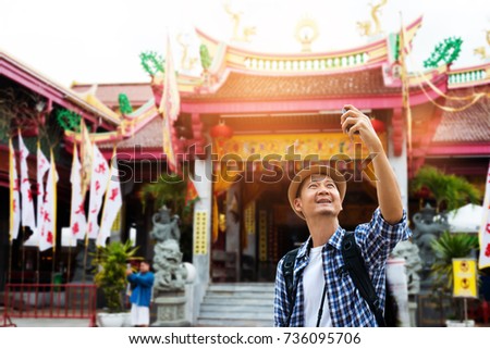 Asian tourist taking selfie at old shrine chinese temple in phuket old town.
Tourist sightseeing old town, travel concept.