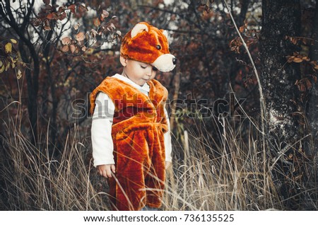 child bear costume in the woods, a very cute and funny, somewhere shy