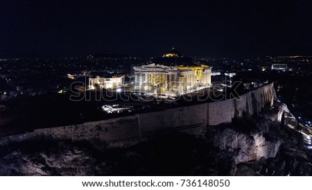 Aerial birds eye view night photo taken by drone of iconic Acropolis hill and the Parthenon, Athens historic center, Attica, Greece