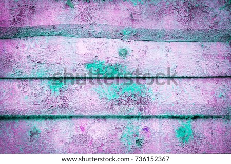 Background and wallpaper or texture of a pink wooden board with blue paint stains