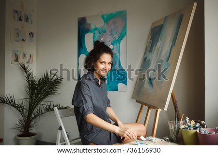 Woman draws picture in home studio. Concept of arts therapy