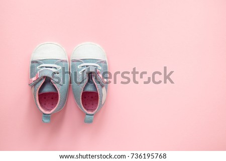 Children's denim sports shoes for girls, stands on a pink background. closeup view from the top. the concept of children's clothing. Royalty-Free Stock Photo #736195768
