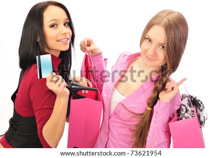 Two young girls laughing and holding their new purchases. Shopping concept