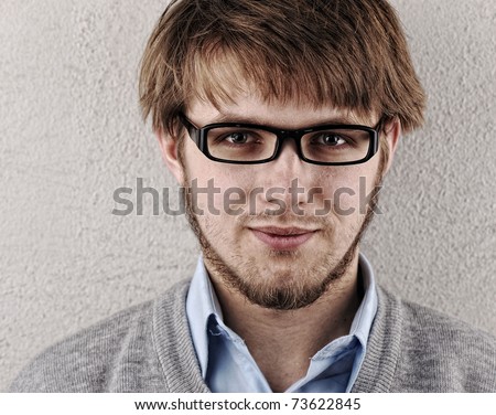Young attractive confident blond man with glasses