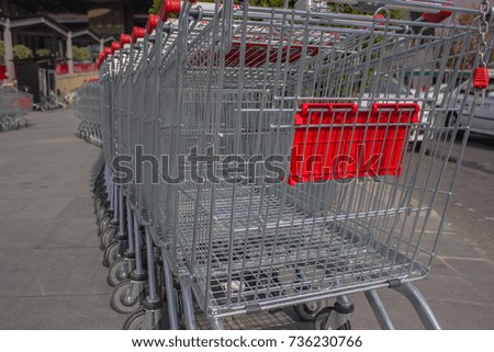 trolleys in the supermarket for products stand in a row of chrome silver color